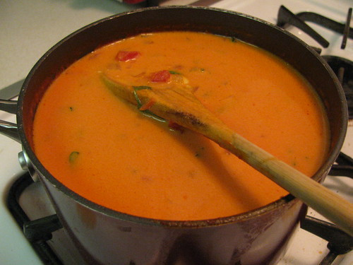 Garnishing Pioneer Woman Tomato Soup with fresh parsley and basil