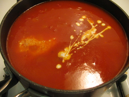 Stirring in sherry and cream into the tomato soup base for Pioneer Woman Tomato Soup