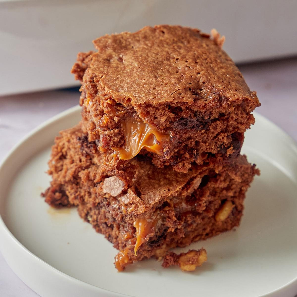 Caramel Brownies, showing gooey caramel brownies topped with walnuts, cut into squares.