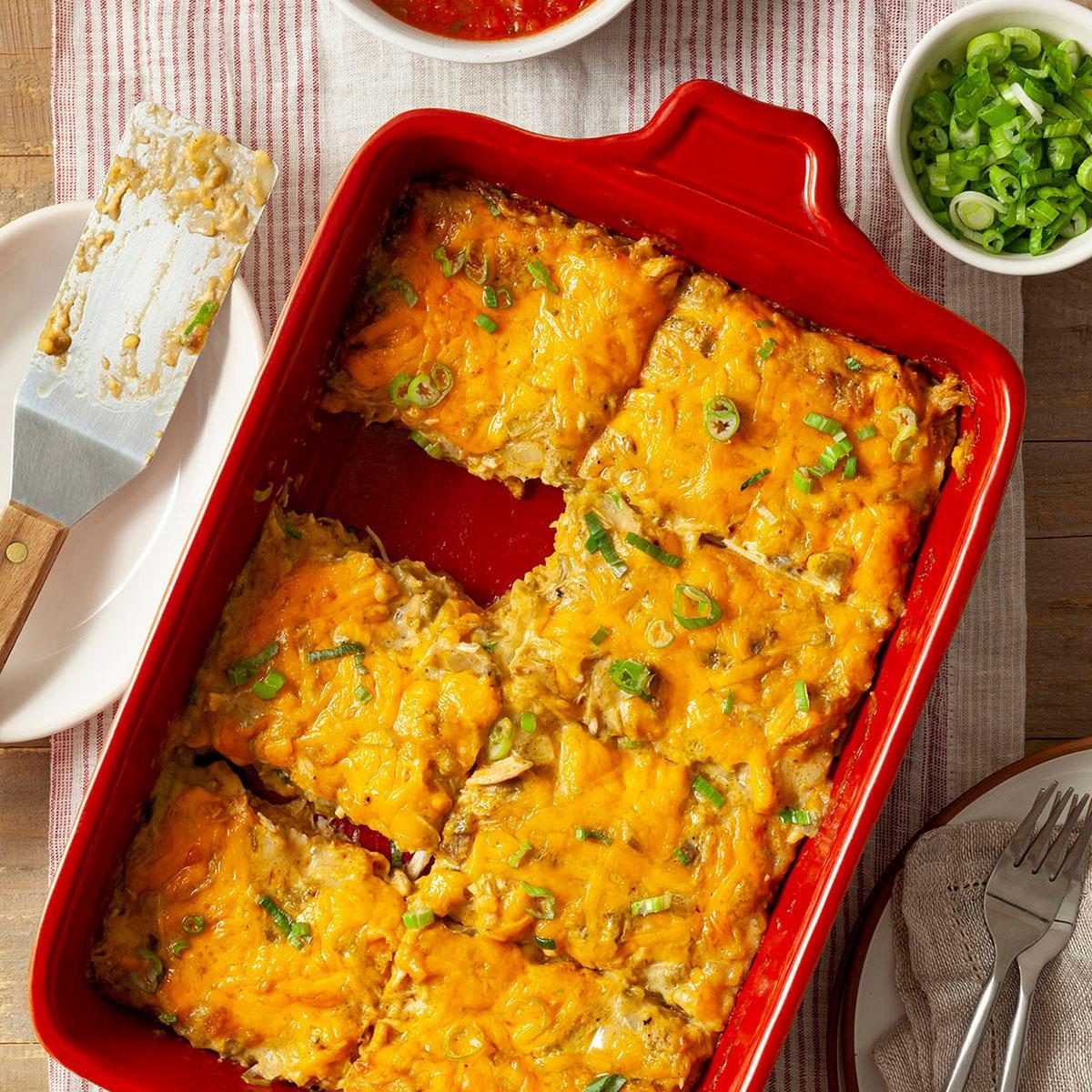 Chicken Tortilla Bake, a cheesy casserole with tortillas, chicken, and vegetables in a baking dish.