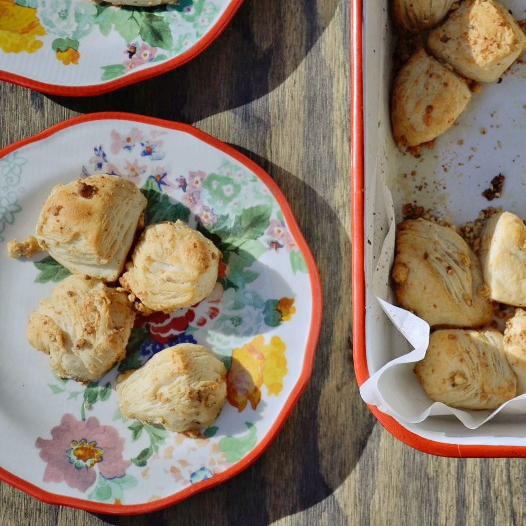 Pioneer Woman Mystery Rolls on a plate, showing golden brown biscuit rolls with blue cheese and butter.