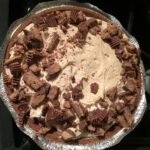 Close-up of a peanut butter pie slice with whipped topping