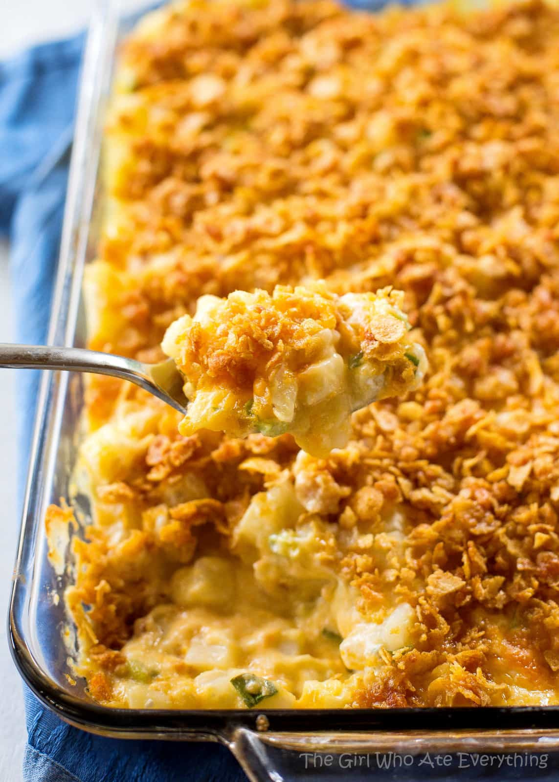 Gooey Potatoes - creamy, cheesy potatoes topped with buttery crunchy cornflakes. Some people call these funeral potatoes but this name is much less morbid. the-girl-who-ate-everything.com