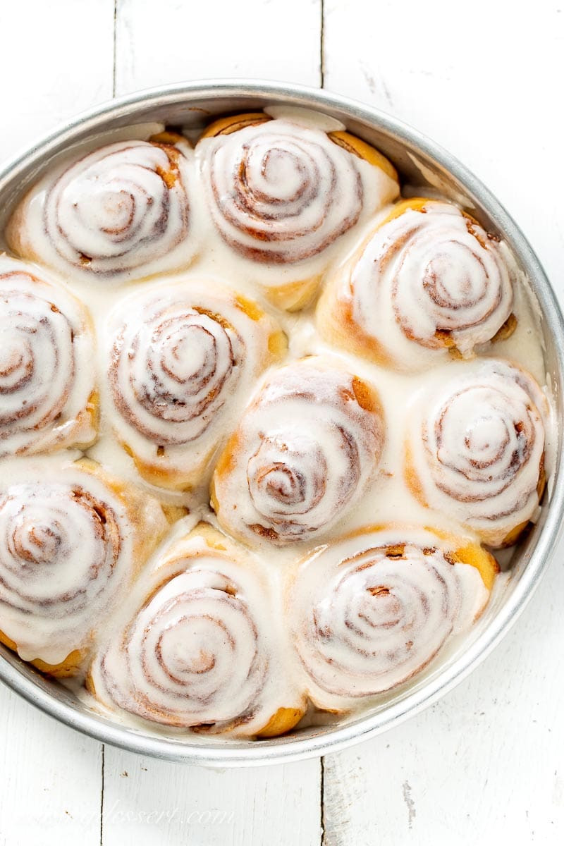 Close up of a pan of frosted cinnamon rolls