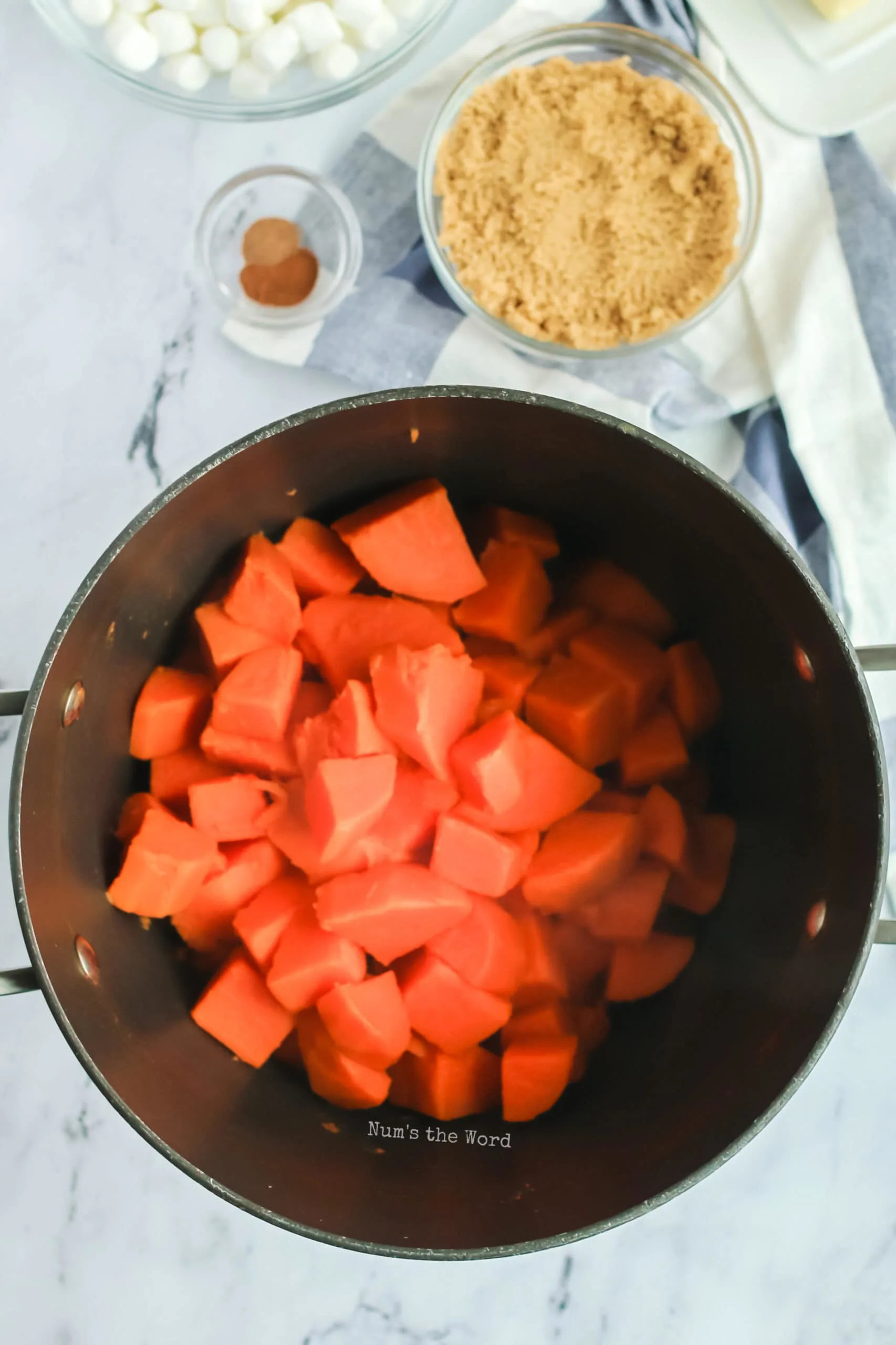 Sweet potatoes boiling in a pot, preparing for Pioneer Woman Sweet Potato Casserole recipe