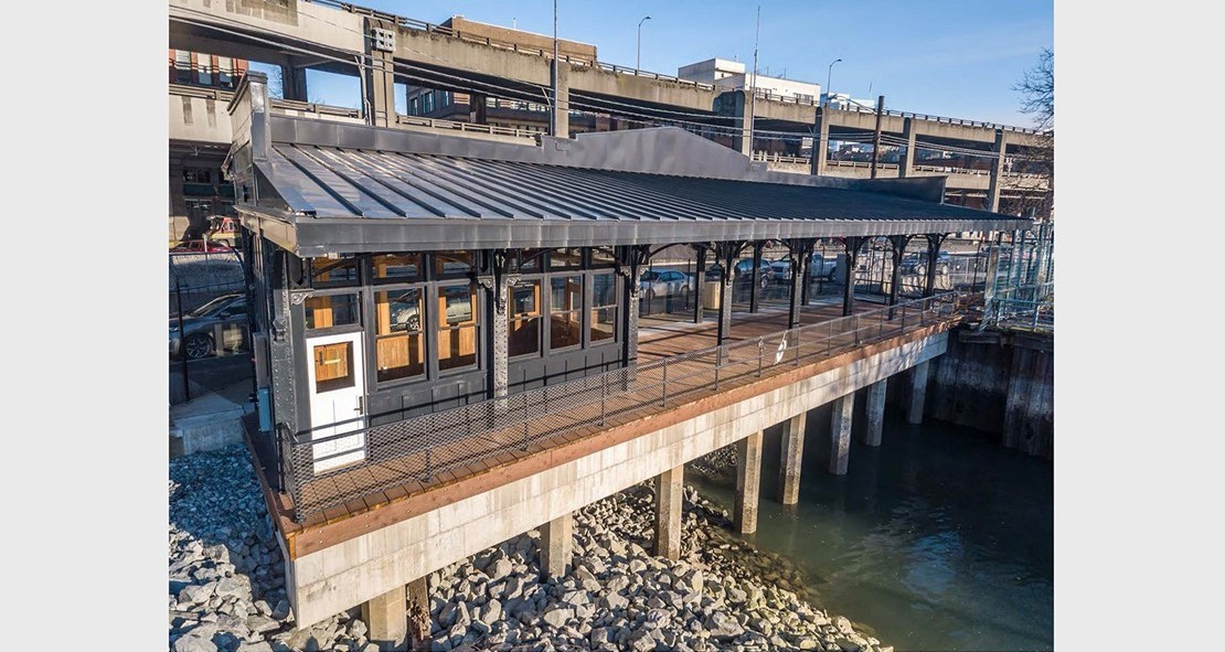 Restored Washington Street Boat Landing Pergola in Pioneer Square South, featuring new lighting and restored ornamentation, ready for public enjoyment.