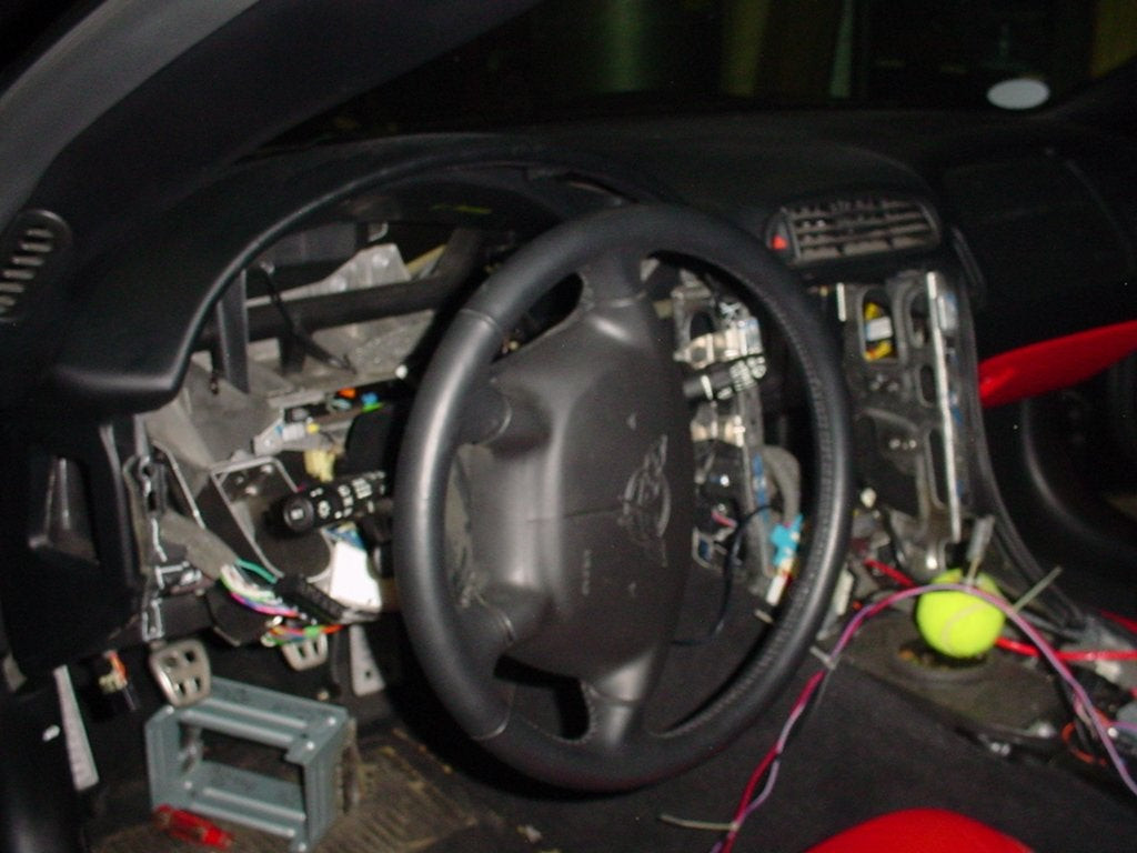 Corvette instrument cluster with speedometer, highlighting the area for accessing VSS wiring for navigation system connection