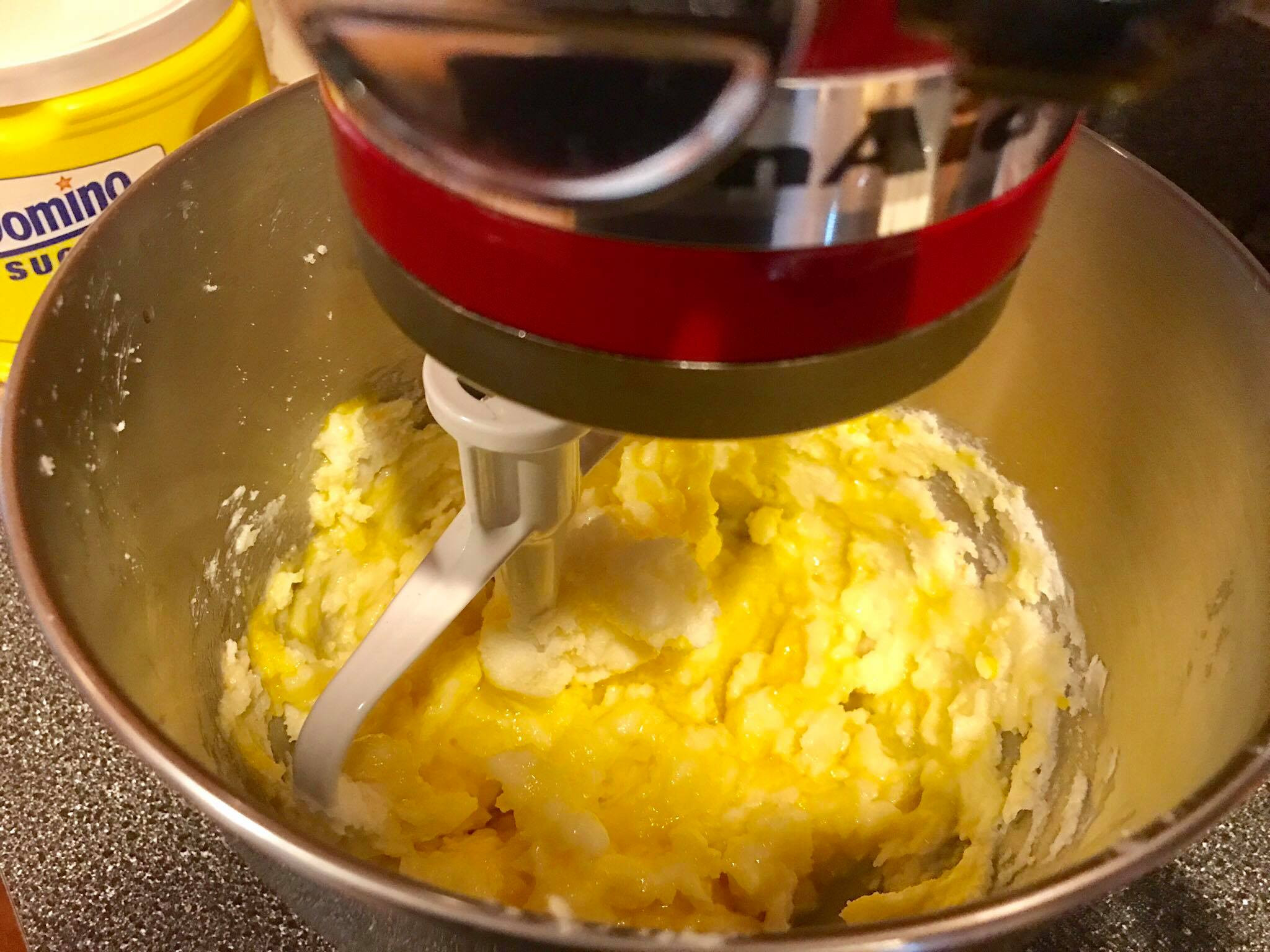 Mixing eggs and vanilla extract into the sugar cookie dough