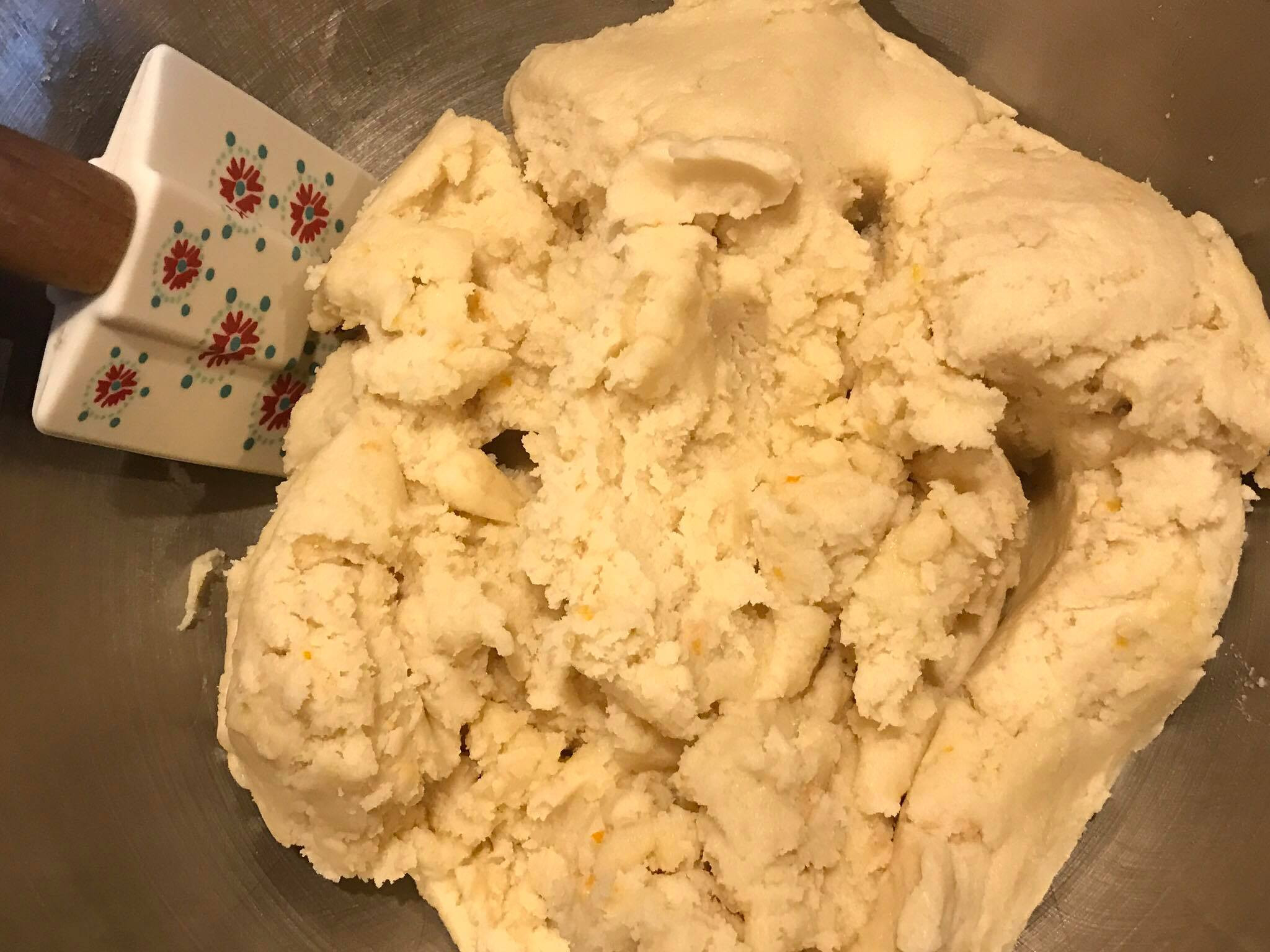 Dividing sugar cookie dough into disks and placing them in plastic bags for chilling