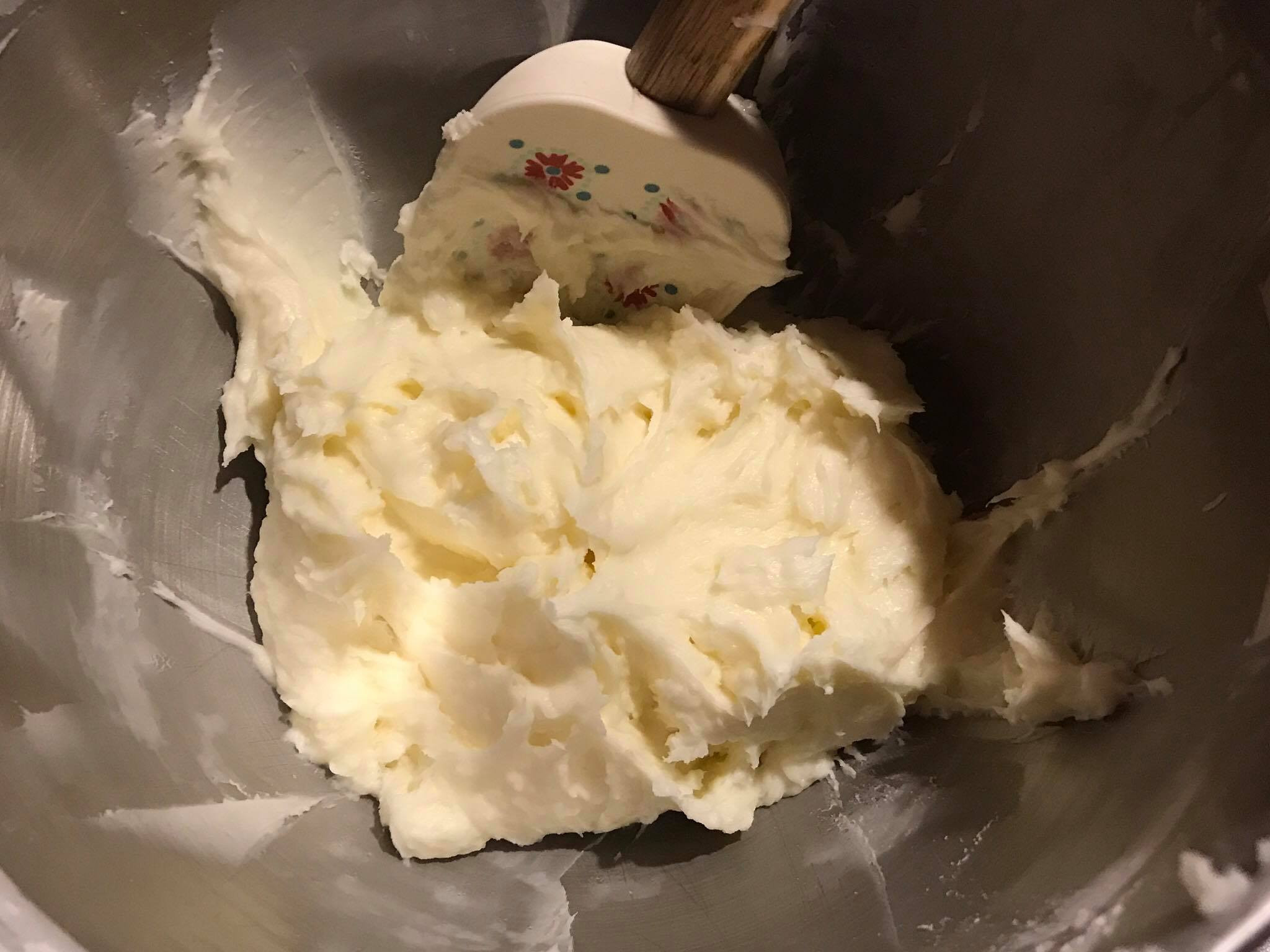 Light and fluffy buttercream frosting in a mixing bowl