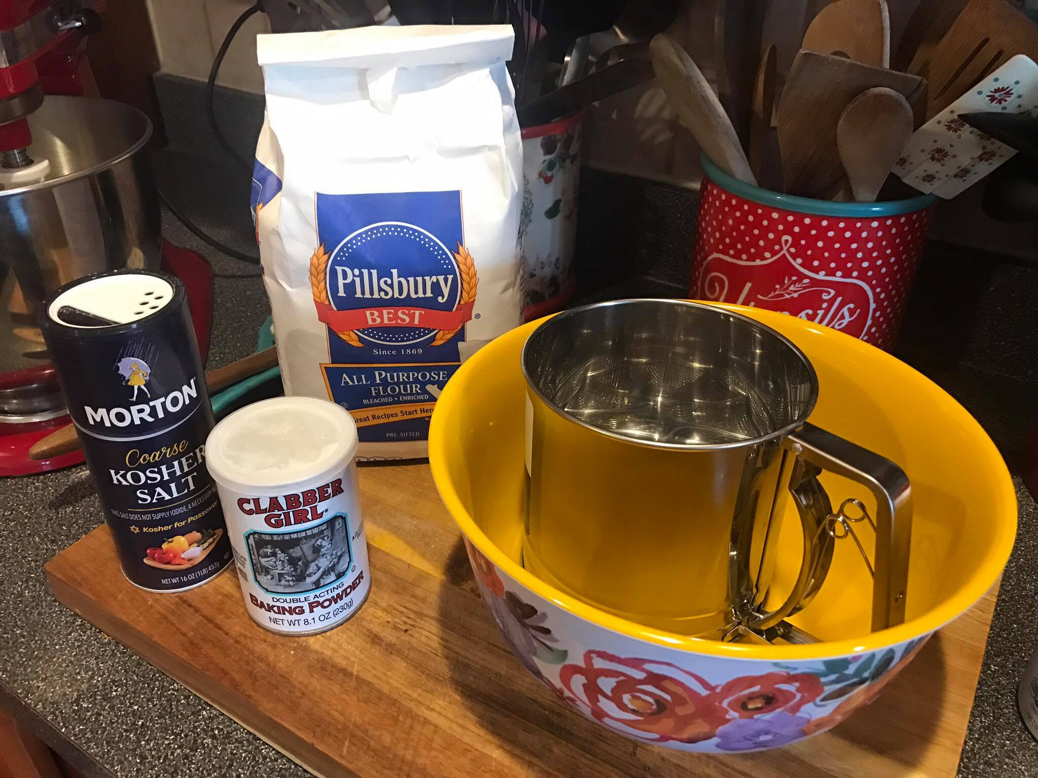 Sifting flour, baking powder, and salt into a large bowl