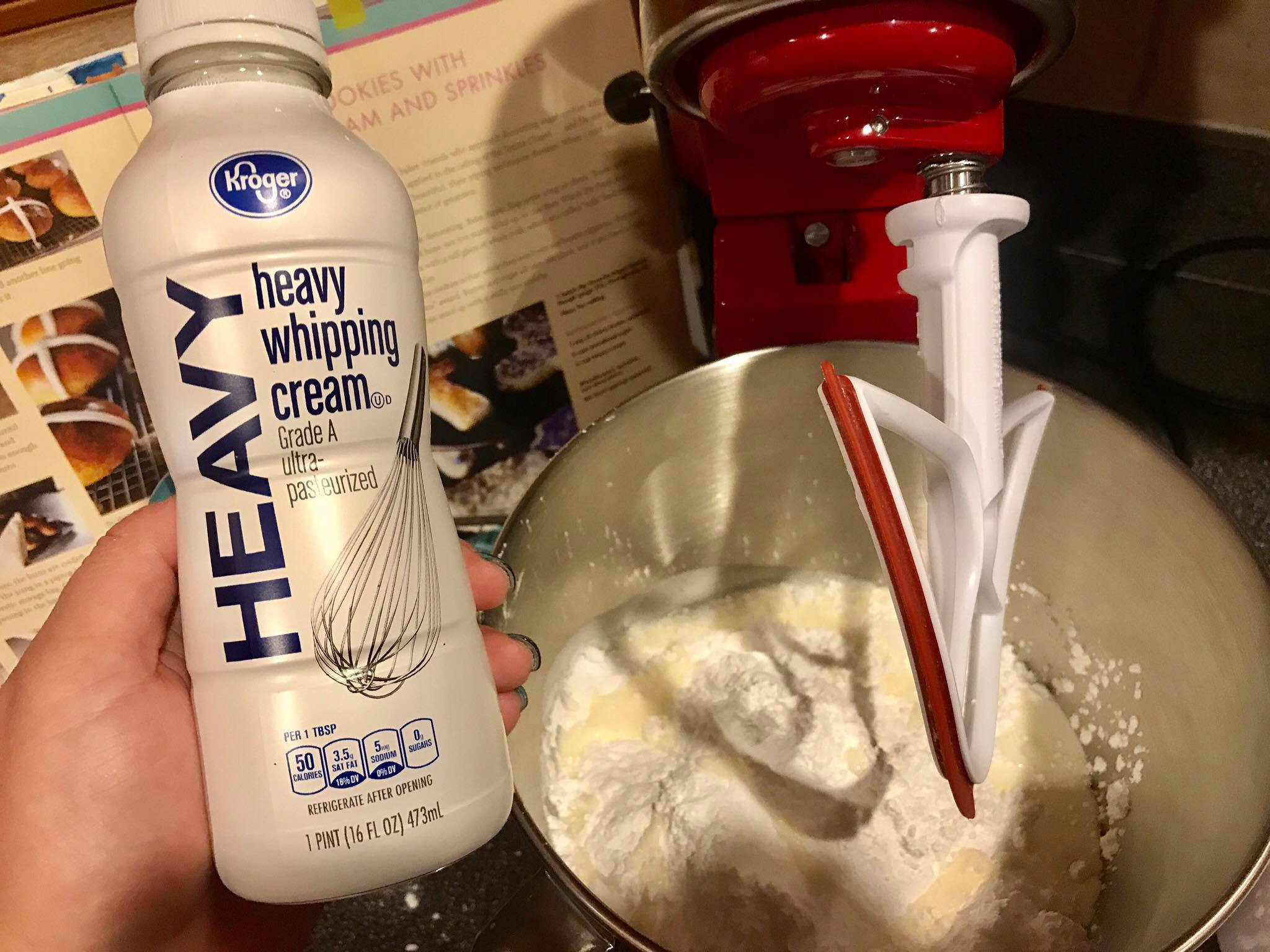 Pouring heavy cream into the mixing bowl for buttercream frosting