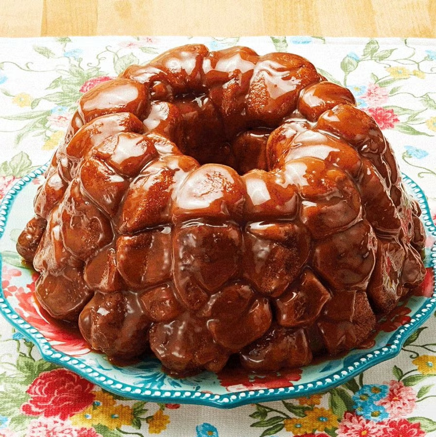 Pioneer Woman Monkey Bread, crowned #1 dessert of 2024, showcasing its pull-apart texture, cinnamon sugar coating and caramel drizzle.