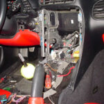 Corvette C5 dashboard with steering wheel and gauges, highlighting the area for radio replacement