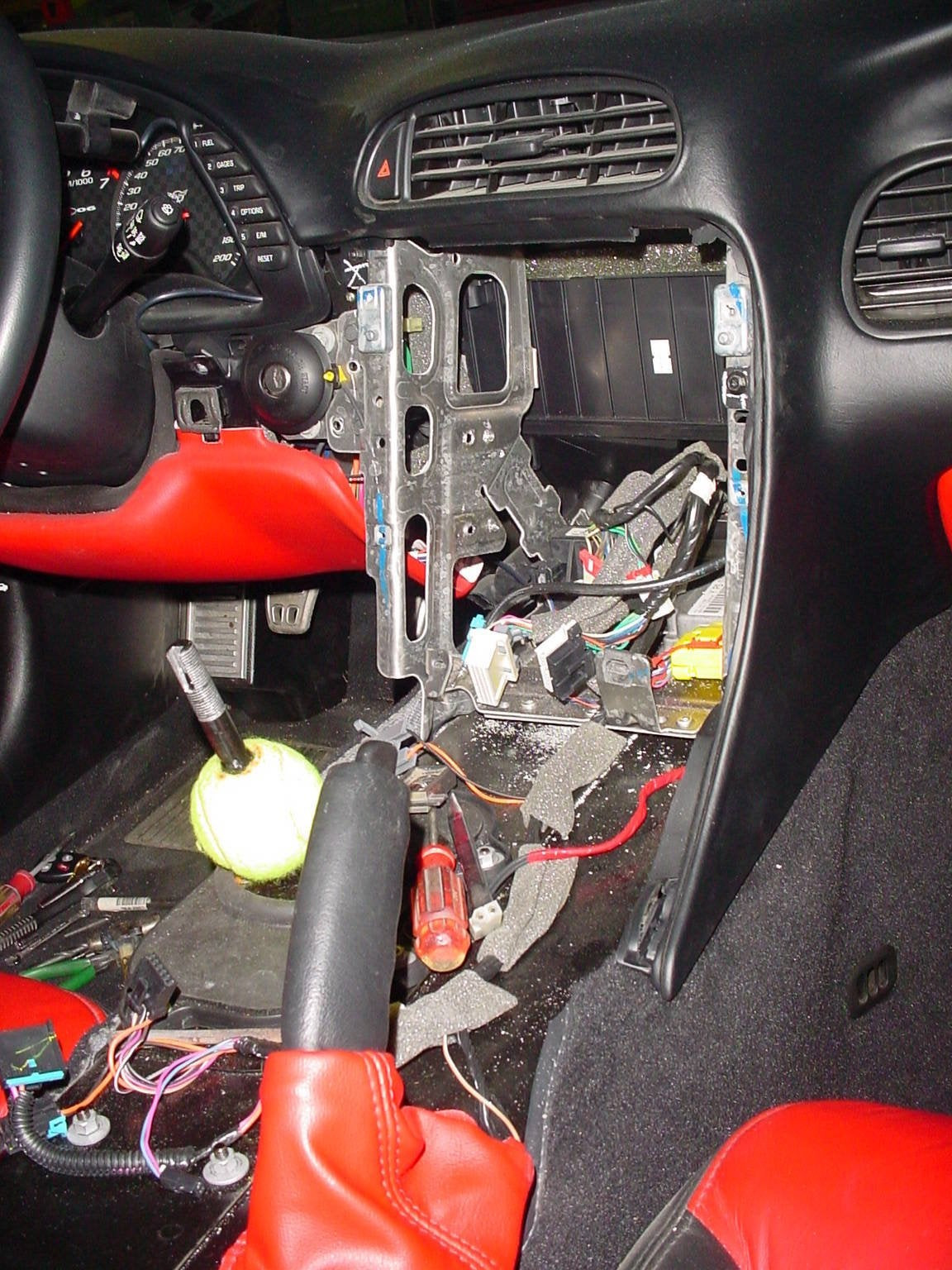 Corvette C5 dashboard with steering wheel and gauges, highlighting the area for radio replacement