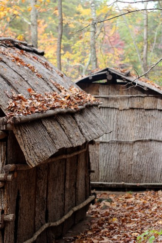 A Native American bark hut settlement, representing the diverse cultural history at the pioneer village