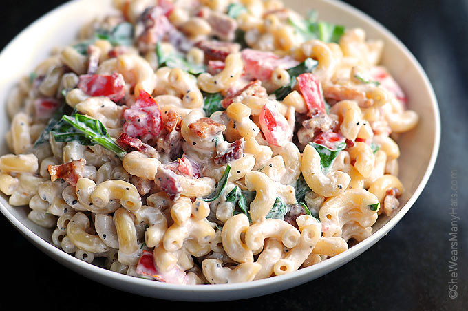 Macaroni pasta salad with bacon bits and fresh vegetables