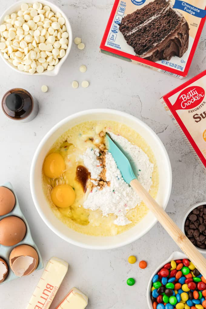 Ingredients for easy cake mix bars: cake mix, eggs, vanilla extract, and melted butter.