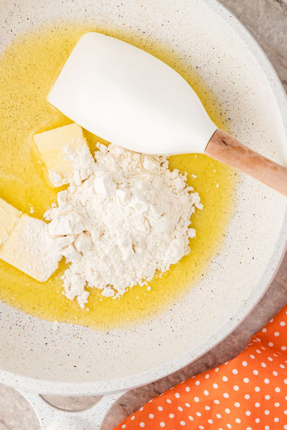 add the flour to the skillet to make a roux
