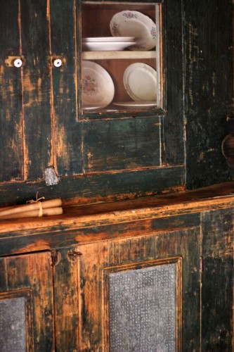 A close-up of a vintage cupboard highlighting the detailed woodwork and historical preservation at Hart Square