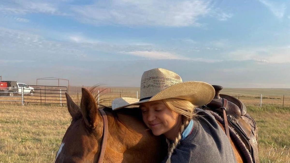 paige drummond hugging her horse 