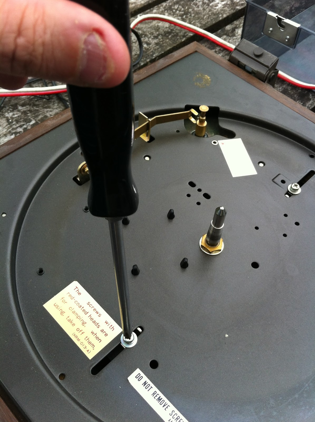 Pioneer PL-12D chassis tilted open, revealing the internal components and spring suspension system.