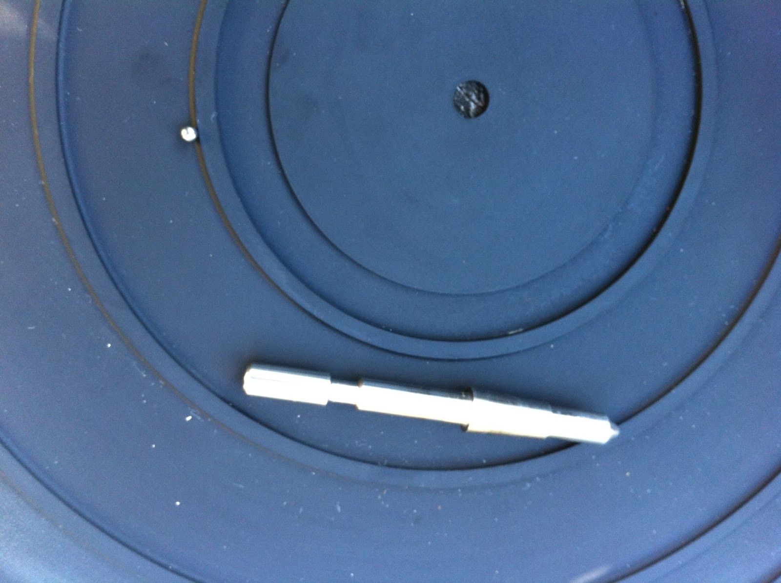 Pioneer PL-12D spindle and bearing components after cleaning, ready for reassembly.