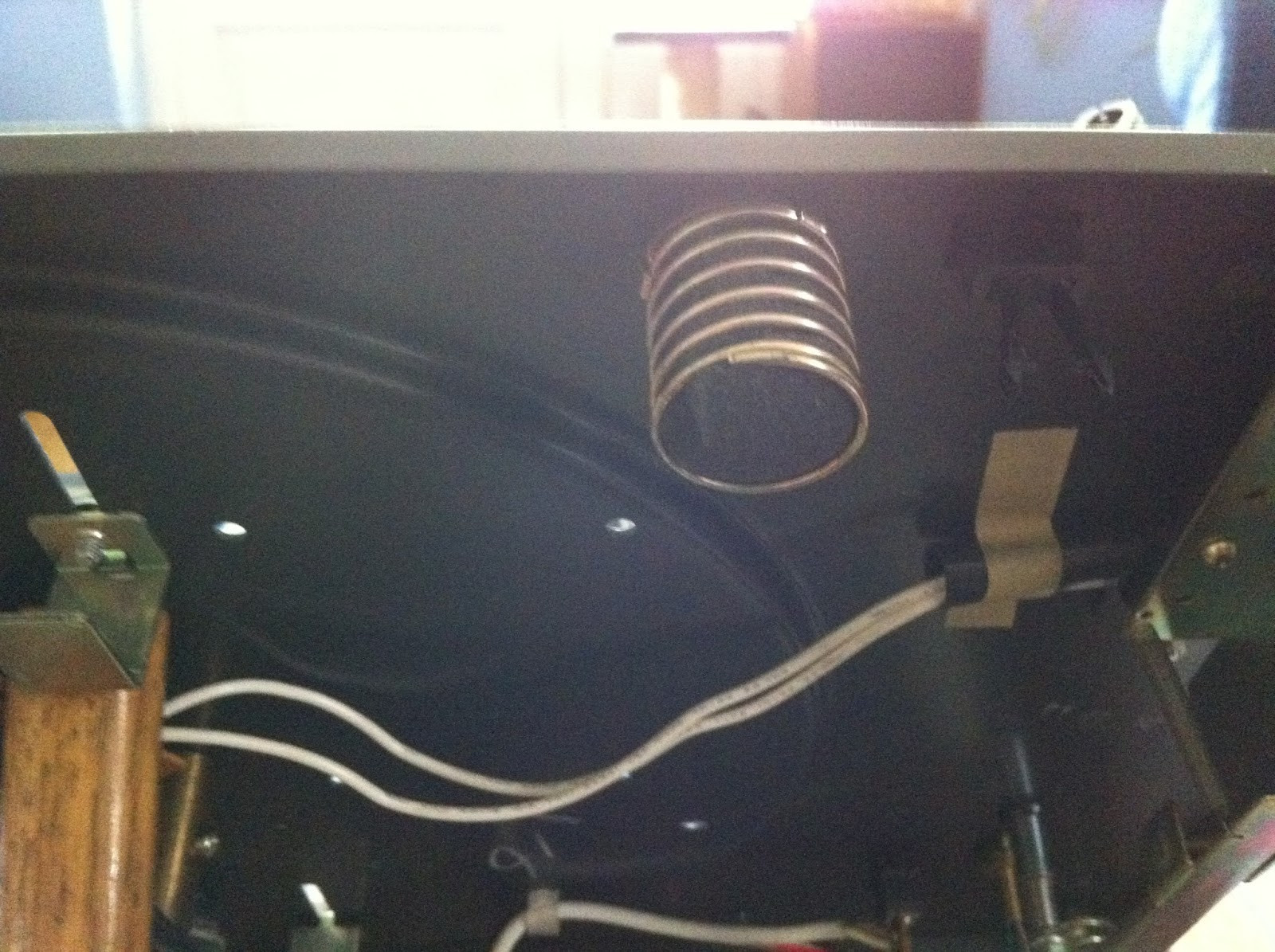 Cutting foam rubber wads to size for insertion into Pioneer PL-12D suspension springs.