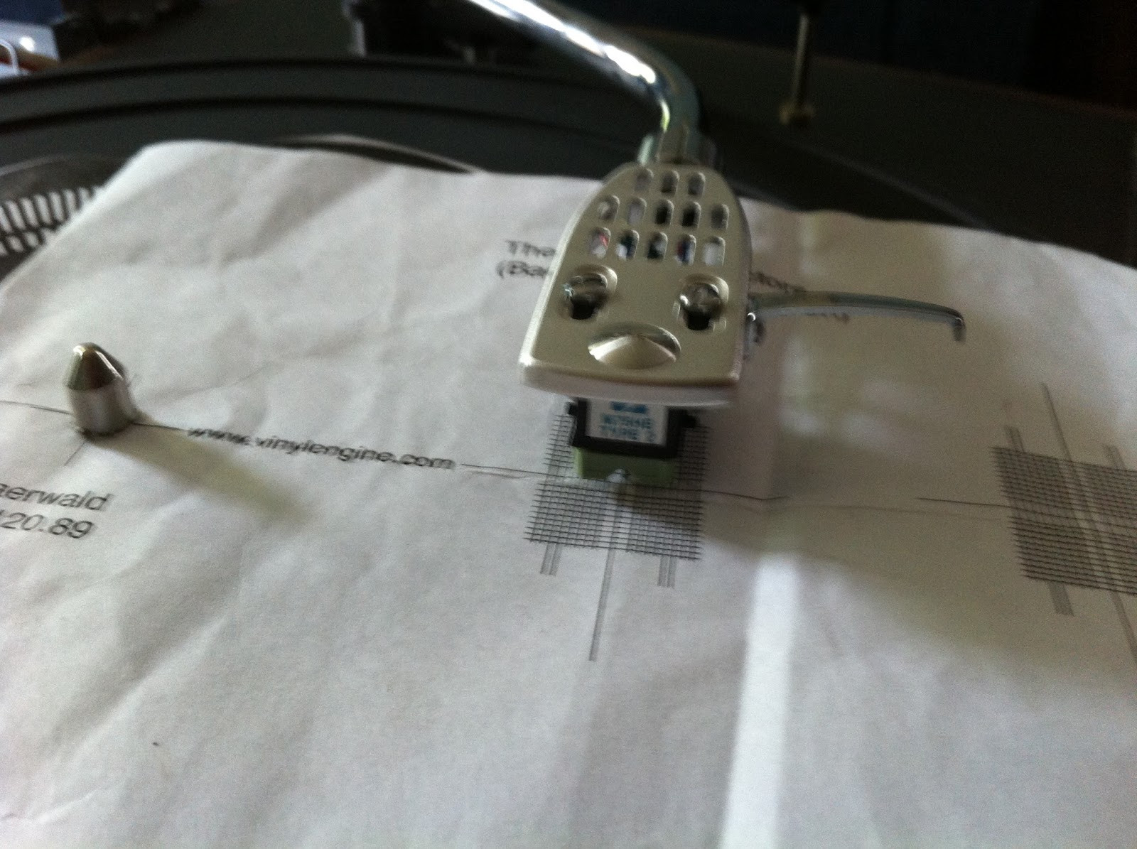 Cartridge alignment on Pioneer PL-12D using Baerwald protractor, showing cartridge parallel to grid lines.