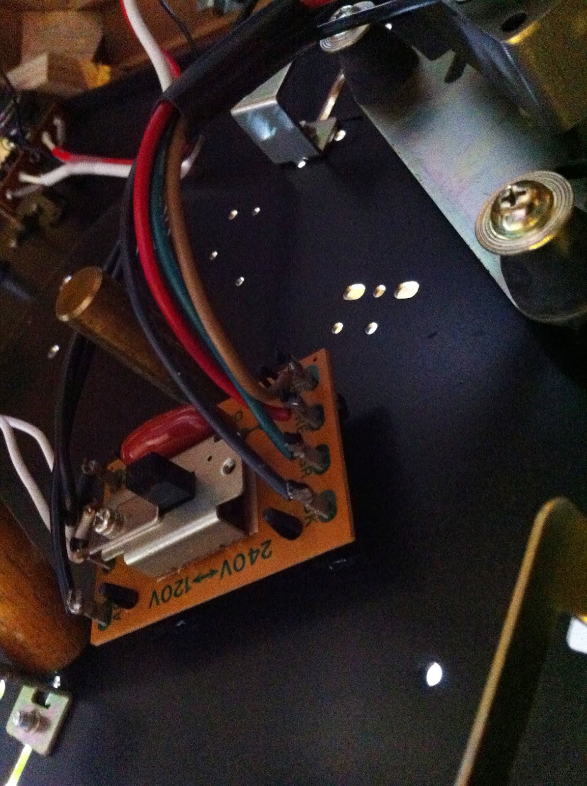 Pioneer PL-12D top plate assembly flipped over for motor access, showing wiring and components.