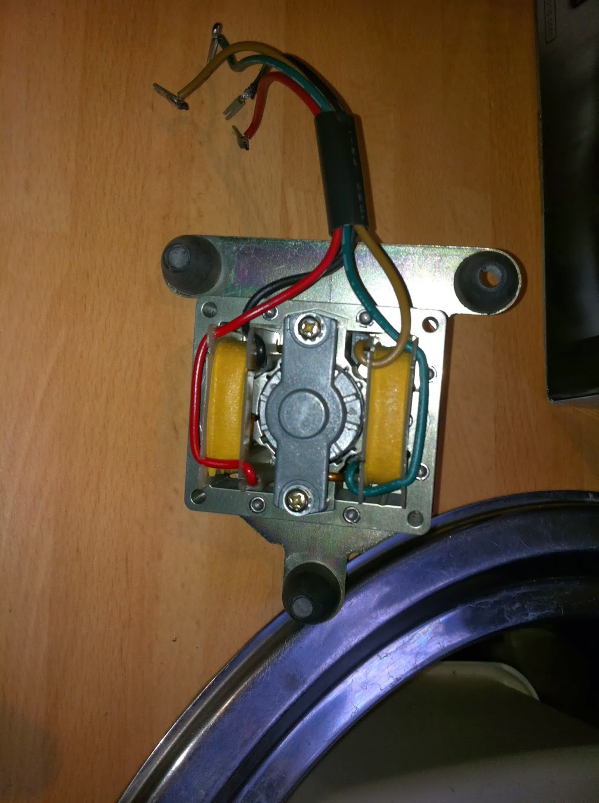 Pioneer PL-12D motor detached after desoldering wires, ready for disassembly and cleaning.