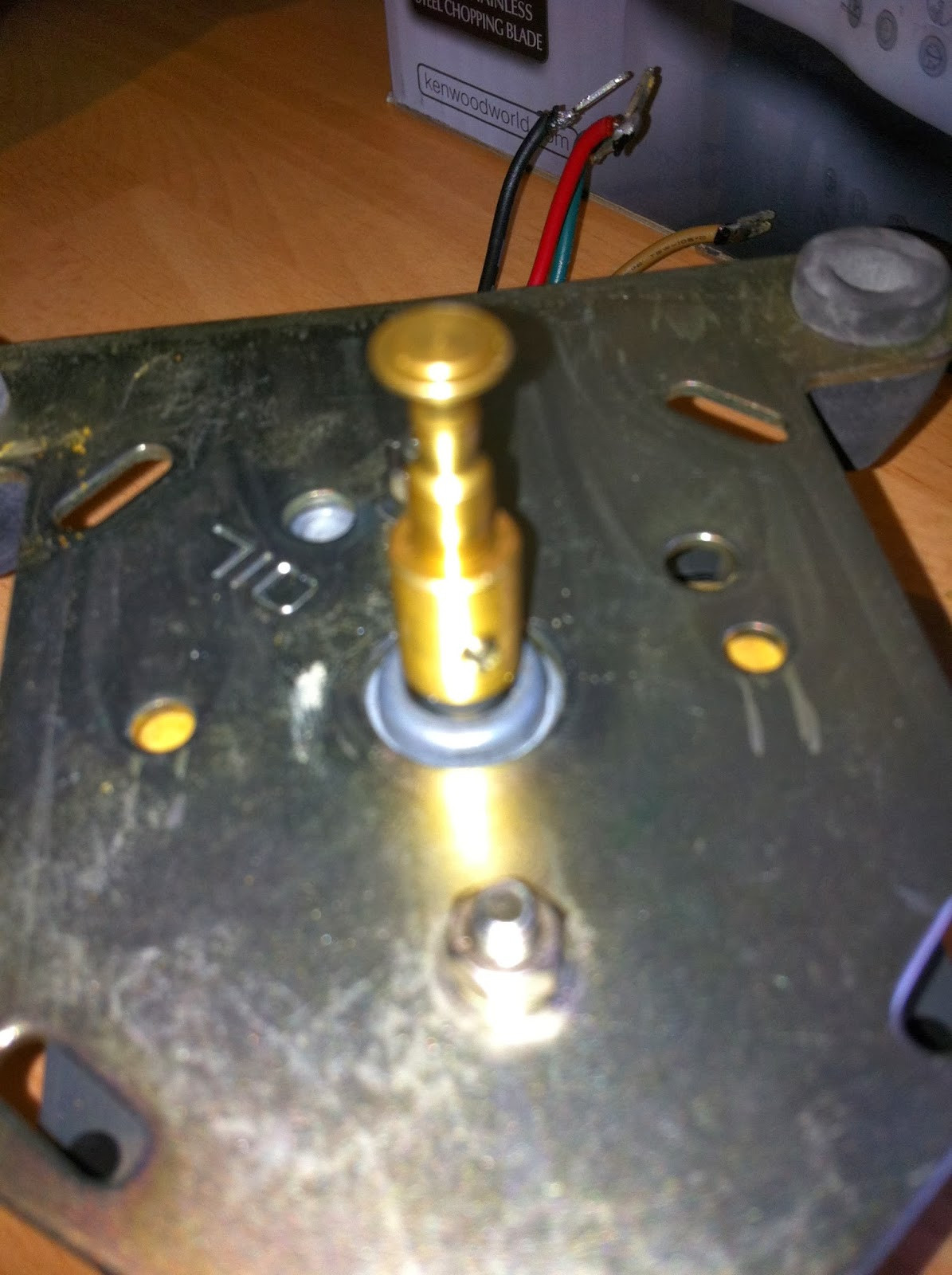 Pioneer PL-12D motor mounting plate removed, exposing motor frame bolts for disassembly.