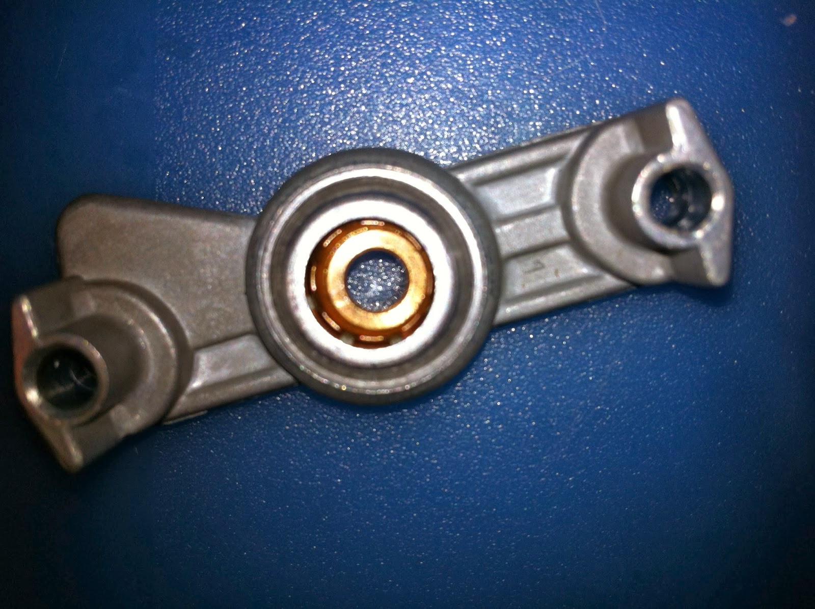 Pioneer PL-12D upper motor bearing frame underside, showing bronze collar bearing and cleaning process.