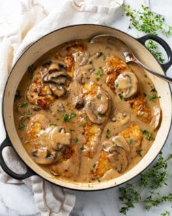 Image of Mushroom Chicken in a creamy sauce, garnished with fresh thyme.