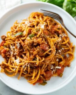 Image of One Pot Spaghetti in a rich meat sauce served on a white plate.