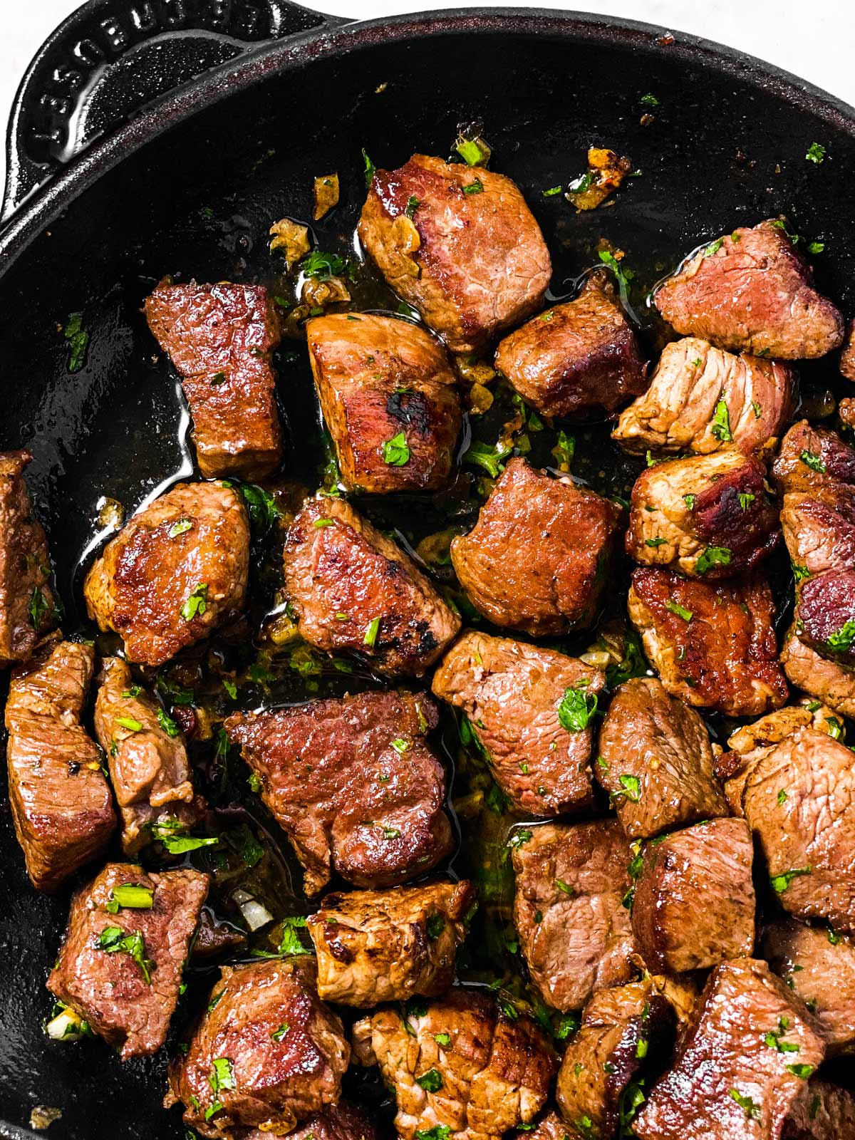 overhead view of pioneer woman steak bites in cast iron skillet