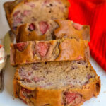 Close-up of a loaf of strawberry bread, showcasing the texture and visible strawberries.
