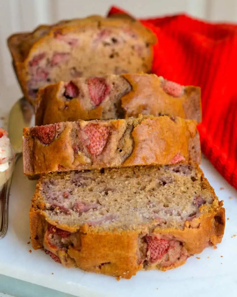 Close-up of a loaf of strawberry bread, showcasing the texture and visible strawberries.