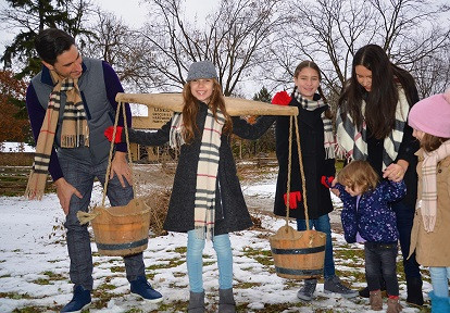 A family enjoying Maple Days event at Pioneer Creek Village